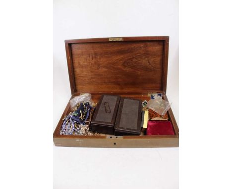 A wooden box containing assorted costume jewellery, enamel pin badges etc 