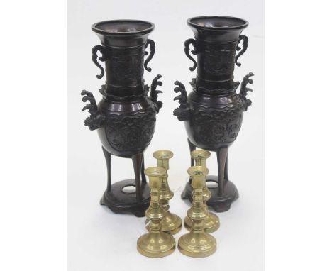 A pair of bronzed vases, each having flared rims to slender necks and bulbous lower bodies decoeated with zoomorphic type fig