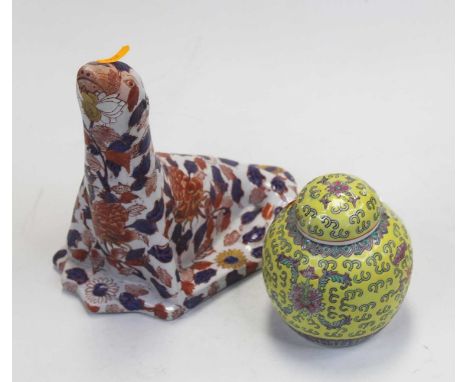 A reproduction Chinese style Imari model of a seal, h.23cm; together with a modern Chinese ginger jar and cover, on a yellow 