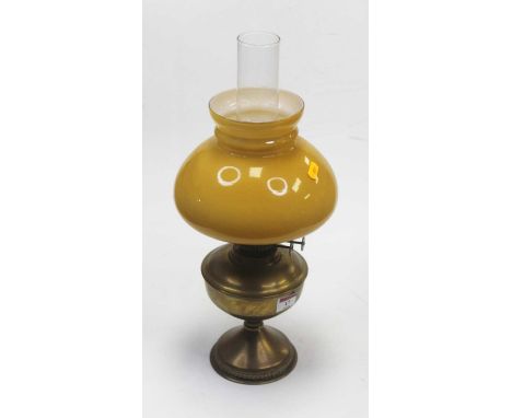 An early 20th century brass pedestal oil lamp having opalescent shade, height 37cm