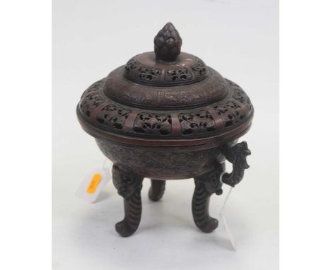 A modern koro and cover, the domed cover with pineapple style finial and pierced floral decoration, the base having twin drag