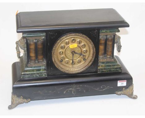A late 19th century faux black slate and marble mantel clock of architectural form having a circular gilt dial with raised Ar