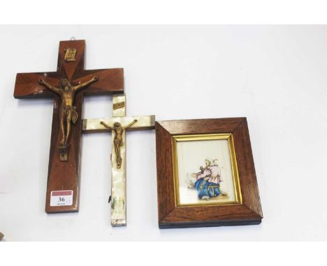 An early 20th century Continental mother of pearl mounted crucifix, 22cm; together with a walnut and gilt metal mounted cruci