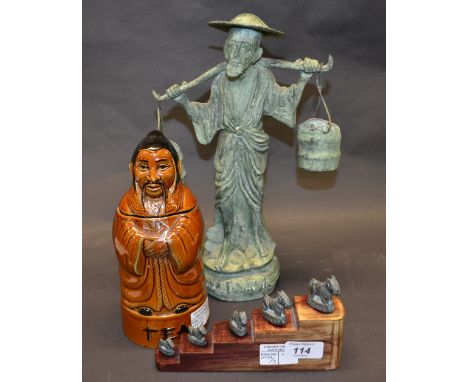 Large Oriental metal figure of a water carrier, plus an Oriental ceramic tea caddy. Plus five metal animal figures. 
