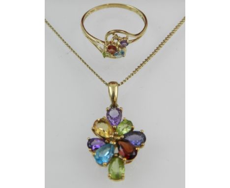 A 9 carat yellow gold and multi gem pendant set with amethyst, peridot, aquamarine, and garnet, suspended on a gold chain, to