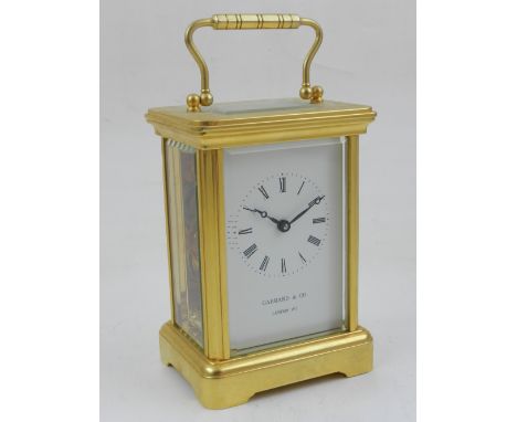 A 20th century brass carriage clock, the enamel dial marked Roman numerals and signed Garrad & Co., London, 11 jewel movement