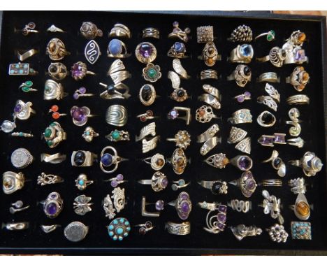 A quantity of silver rings set with various semi-precious gemstones, to include amethyst, tigers eye, turquoise, lapis lazuli