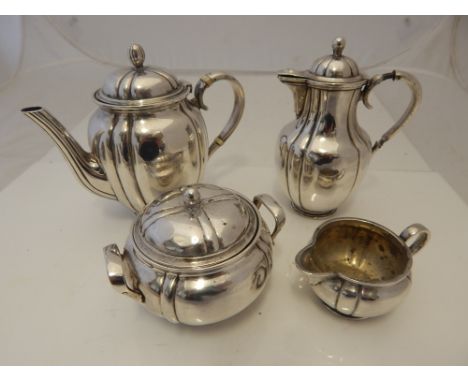 An early 20th century French silver four piece bachelor's tea service of fluted circular baluster form comprising teapot, wat