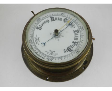 A large early 20th century bulk-head aneroid barometer, the white vitreous dial marked in inches within a brass case, D. 28cm