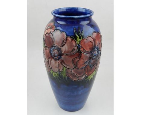 A Moorcroft pottery anemone pattern baluster vase, the pale red flowers on a light blue mottle glazed body, h:25cm