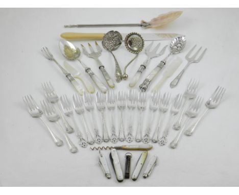 Assorted mother of pearl handled utensils including berry spoon, serving forks, folding pocket knives, one with tortoiseshell