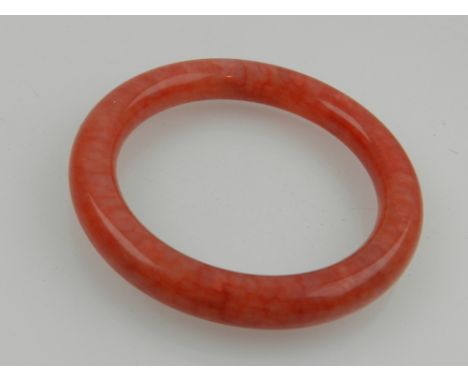 A Chinese chicken blood jade bangle.  D: 6cm (internal)