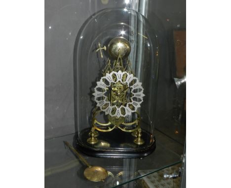 A late 19th century brass skeleton clock, of architectural form, the pierced and silvered chapter ring with engraved Roman nu