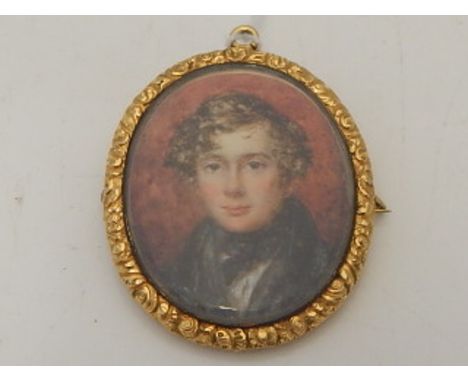 A 19th century yellow metal mounted pendant brooch, set portrait miniature, depicting a young gentleman, having glass apertur