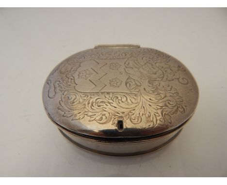 An 18th Century oval white metal table snuff box, the cover with engraved armorial, 9cm