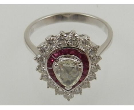 An 18 carat white gold, diamond, and ruby cluster ring, set pear shaped rose cut ruby of 0.40 carats, surrounded by calibri c