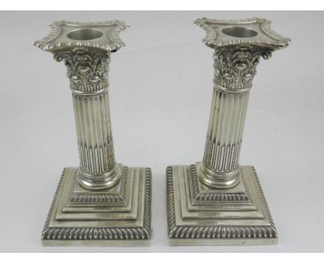 A pair of late Victorian silver corinthium column dwarf candlesticks with gadrooned detatchable sconces, Hutton & Sons, Londo