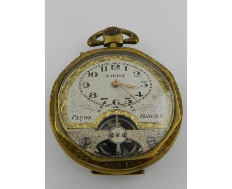 A brass Amida Facon 8 day open faced pocket watch, the silvered dial with Arabic numerals, visible escapement, engine turned 