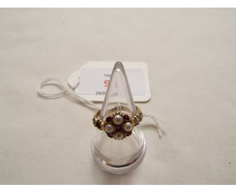 A 9ct gold ring inset with seed pearls and rubies 