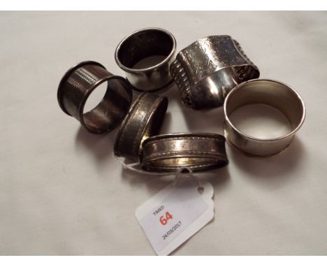 Five assorted silver napkin rings and an Alpaca white metal napkin ring