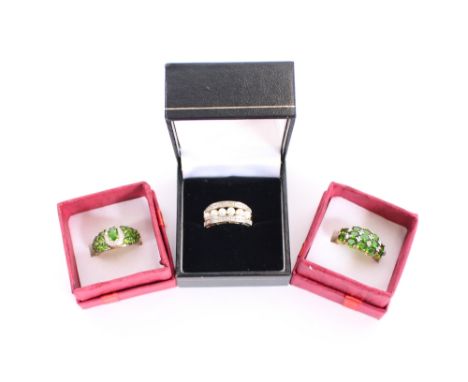 A 9 carat gold pearl and white stone dress ring; a 9 carat gold dress ring set emerald coloured and white stones; and a yello