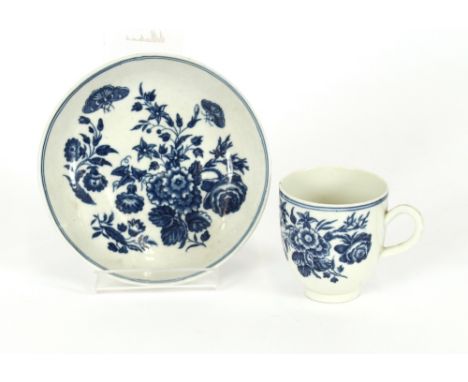 An 18th Century Worcester tea cup and saucer, decorated with blue and white foliage