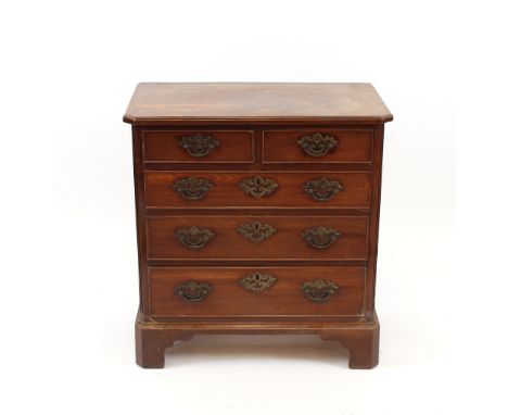 A George III mahogany chest, of small proportions, the canted corner top above two short and three long graduated drawers, ra