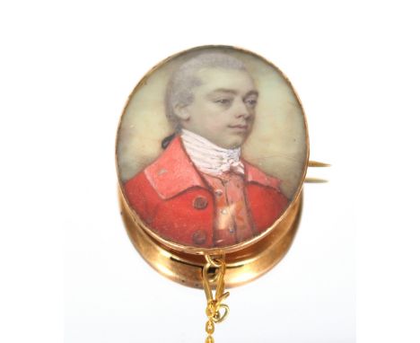 A miniature portrait pendant brooch, decorated scene of a young gentleman wearing stock and hunting jacket