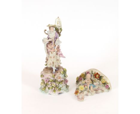 A German porcelain figure of a lady, standing before a floral encrusted tree stump, surmounted by a parrot in cage, 31cm high