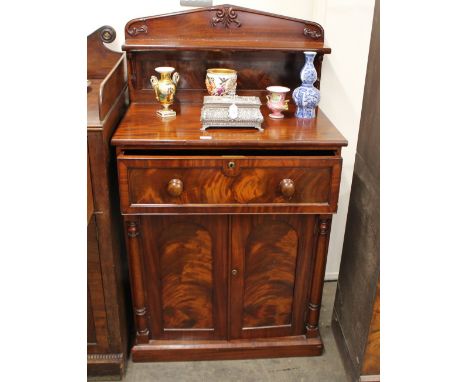 A Victorian figured mahogany secretaire chiffonier, having raised shelf back, decorated foliate scrolls, the secretaire drawe