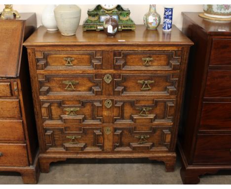 An oak chest, in the Jacobean manner, fitted two short and three long geometric moulded drawers, raised on bracket feet, 90cm