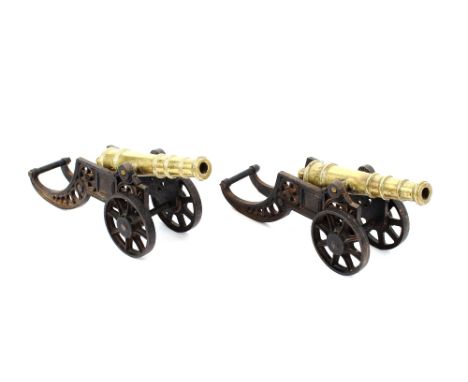 A pair of brass and iron models of military field cannon, 47cm long
