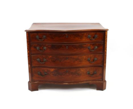 A George III mahogany serpentine fronted chest, fitted four long graduated drawers within marquetry decorated stiles, the top