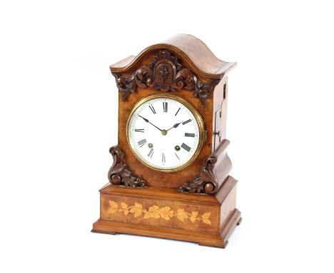 A Victorian burr walnut and inlaid cuckoo mantel clock, having applied carved foliate decoration, circular Roman numeral dial