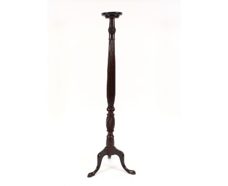 A 19th Century mahogany torchere stand, raised on a turned baluster fluted column, terminating in tripod base