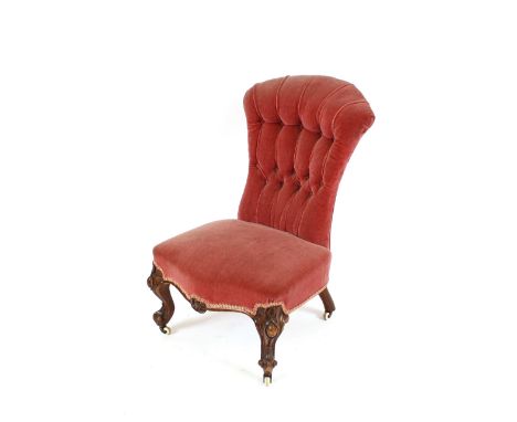 A Victorian upholstered nursing chair, with button back, serpentine fronted seat, on French style cabriole legs terminating i