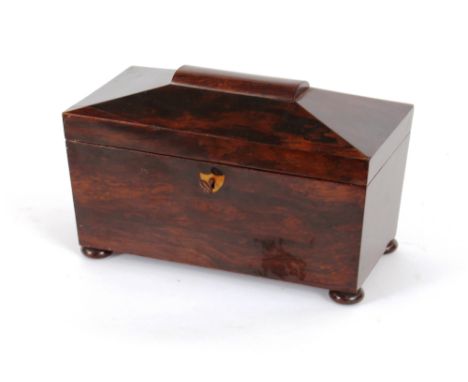 A 19th Century rosewood sarcophagus shaped two compartment tea caddy, having aperture for mixing bowl, raised on bun feet, 32