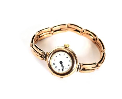 A 9 carat gold ladies wrist watch, having circular enamel dial and expanding bracelet strap, hallmarked 1914