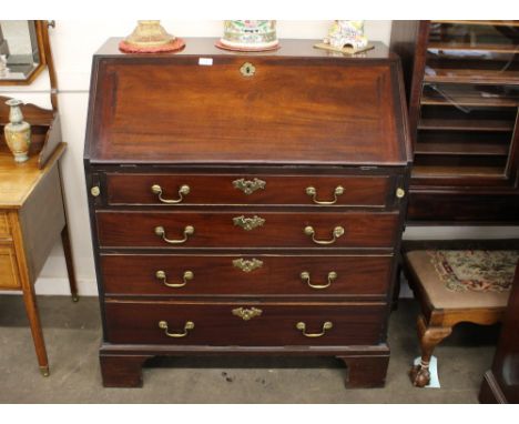 A George III mahogany bureau, the fall flap opening to reveal a fitted interior, four long graduated drawers below on bracket