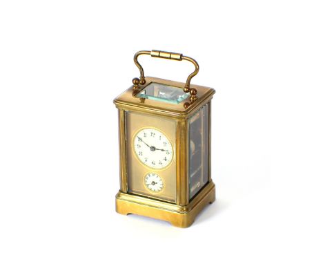 A small brass cased carriage clock, having circular white enamel dial and seconds subsidiary, stamped D.H. to the backplate, 