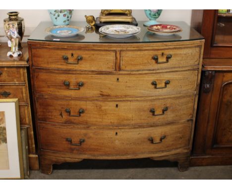 A George III mahogany bow fronted chest, of two short and three long graduated drawers, raised on bracket feet, 107cm wide