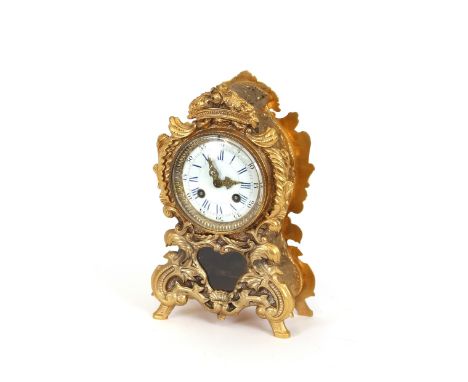 A 19th Century French gilt metal mantel clock, having profuse foliate decoration, circular blue enameled Roman numeral dial a