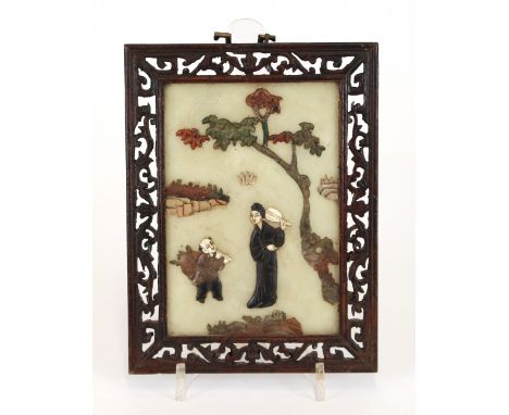 A pair of jade and hardstone plaques, depicting figures in exotic garden landscapes, contained in pierced hardwood frames, 20