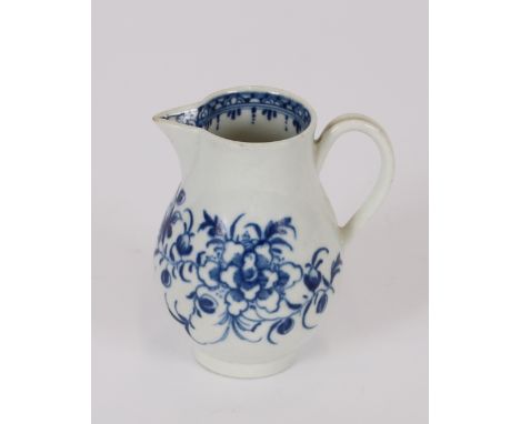 An 18th Century Worcester blue and white bird beak cream jug, decorated with floral sprays, crescent mark to the circular rai