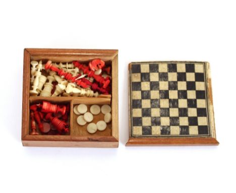 A miniature ivory chess set, and draughts set, contained in decorated chequered box