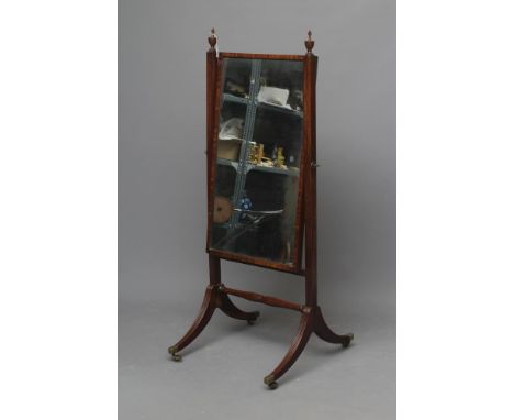 A REGENCY MAHOGANY CHEVAL MIRROR, the oblong plate suspended on moulded square uprights with turned vase finials, raised on r