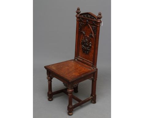 A VICTORIAN GOTHIC POLLARD OAK CARVED HALL CHAIR, the high back with arched foliate carved top rail over an arched panel cent