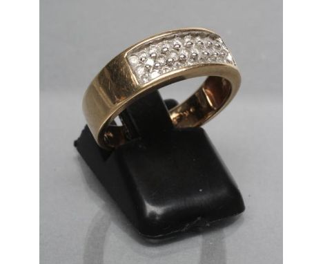 A DIAMOND BAND RING, the wide 9ct gold panel point set with three rows of three small diamonds, London, size O 1/2 (Est. plus