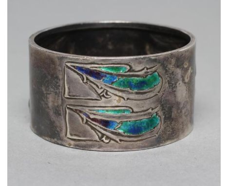 AN EDWARDIAN ARTS AND CRAFTS SILVER NAPKIN RING, maker WH Haseler, Birmingham 1908, chased with three pairs of blue and green