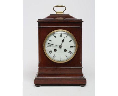 A MAHOGANY CASED TABLE CLOCK, the twin barrel movement striking on a gong, the white enamel dial with Roman numerals, the can